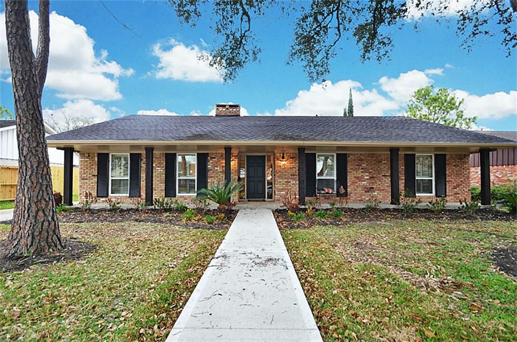 Brick ranch home with mature landscaping